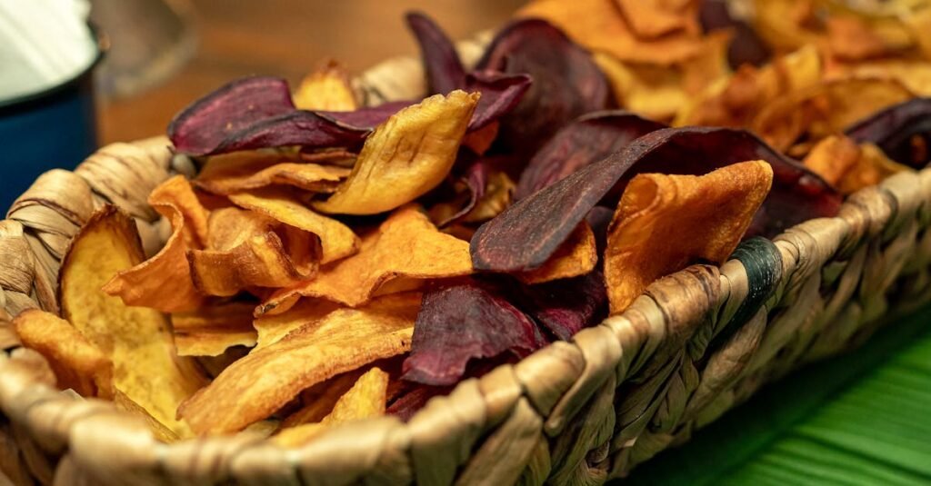 Close-up of a woven basket holding colorful dried vegetable chips.